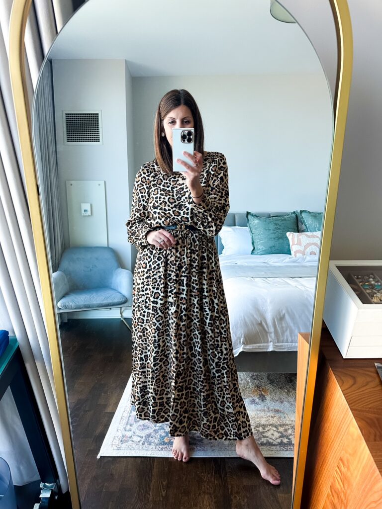 Woman wearing a leopard print dress for a professional office loo