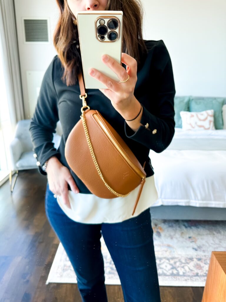 Mom wearing the GiGi New York Beck Sling Bag hands-free with adjustable strap