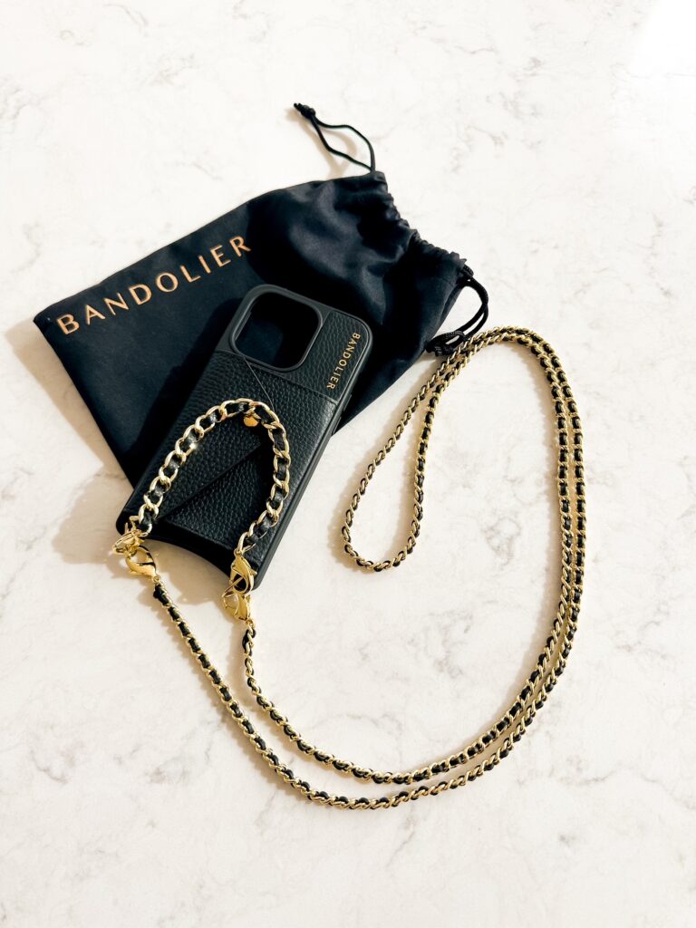 Close-up of the Bandolier phone case with card slots and essentials tucked inside