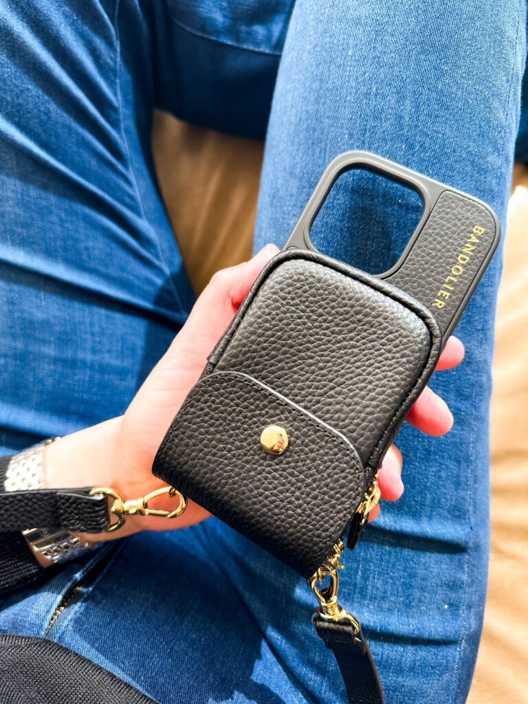 Mom in jeans wearing a Bandolier crossbody phone case